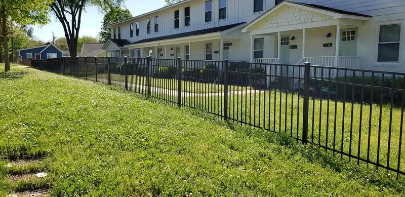 Black aluminum fence stepping down a sloped yard
