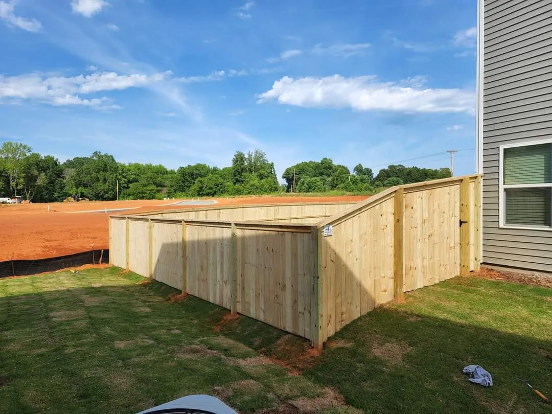 Board on board wood privacy fence around a new build back yard
